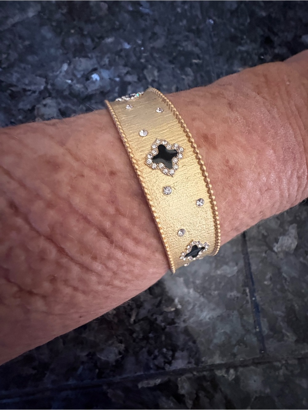 Gold Toned Clover Bangle Bracelet with Black Inlay